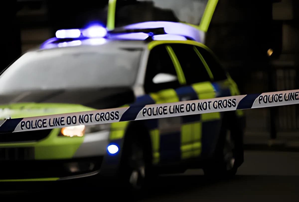 blurred police car with police line tape