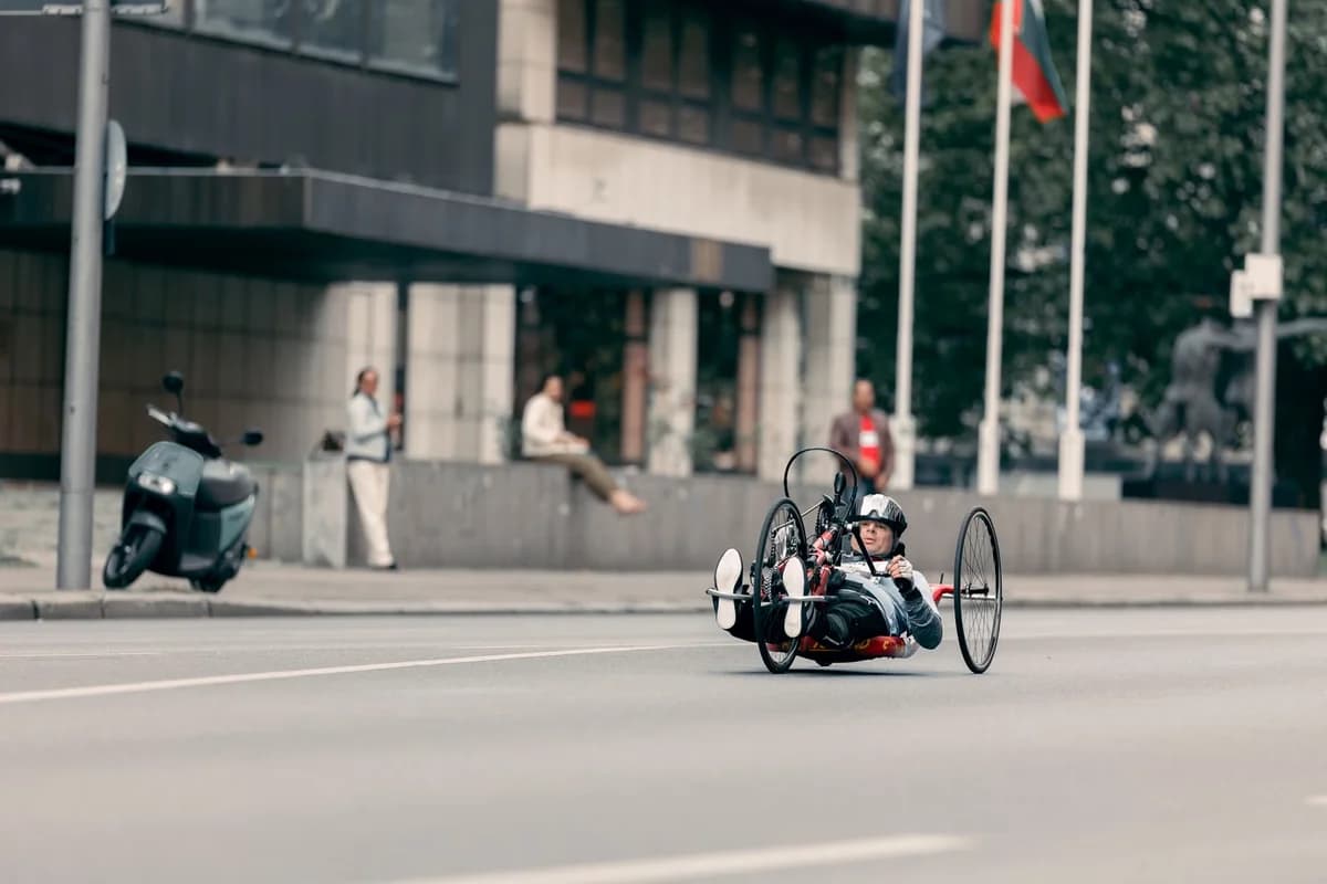 Man riding a handcycle on an urban street