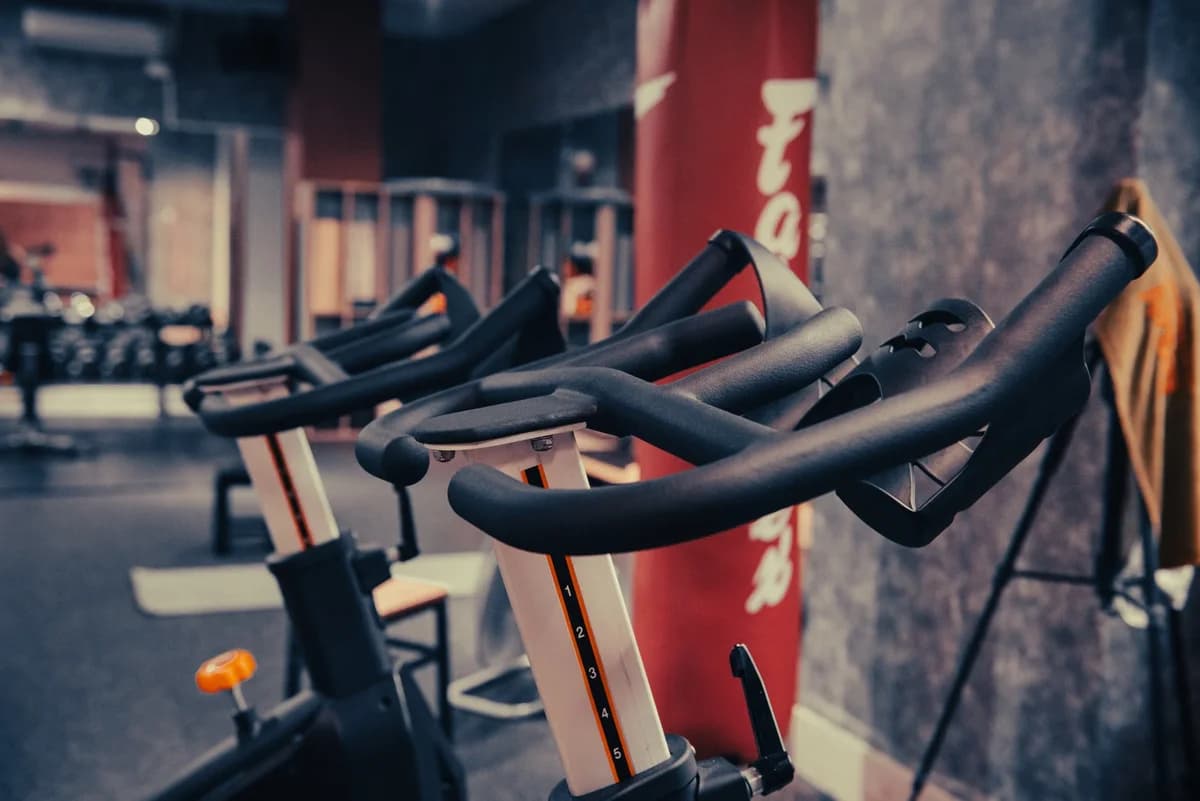 Close-up of stationary exercise bikes in a gym.