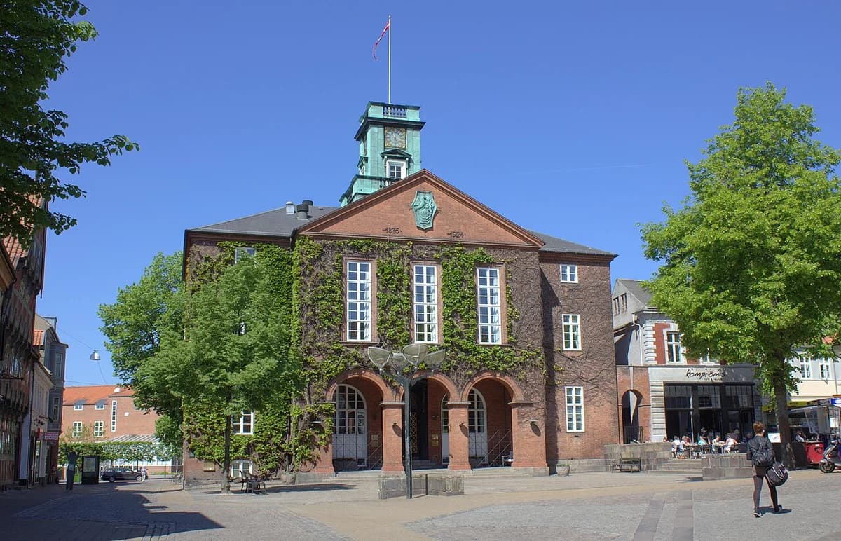 Kolding City Hall in Denmark with a clock tower and brick facade.
