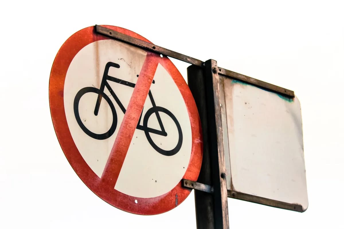 Worn no bicycles allowed traffic sign